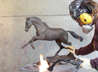 Applying the patina to the sculpture of Griffin