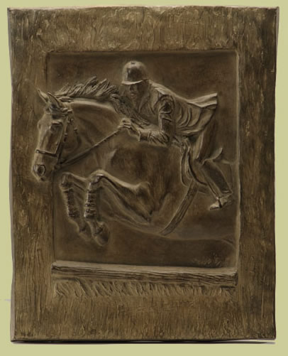 Bronze relief of horse jumping over fence
